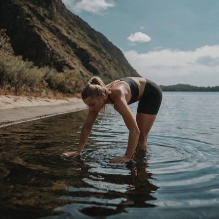 woman-is-doing-yoga-water-by-mountain